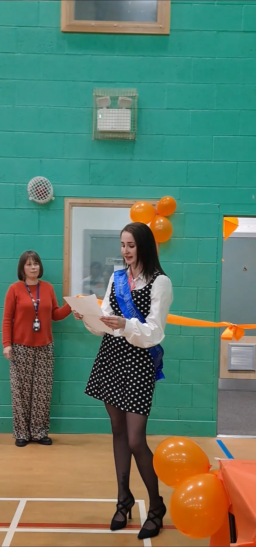 Emma speaking at a lectern